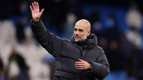 Pep Guardiola waves to crowd after match