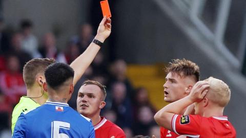 Odhran Casey reacts to being sent off
