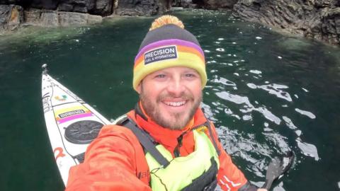 A man in a kayak in a cave