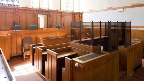 Interior of Kingston Magistrates Court in Surrey UK showing the magistrate's bench and defendant's docks. 