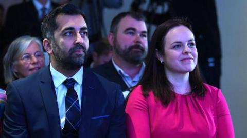 Humza Yousaf and Kate Forbes pictured sitting waiting for the result of the 2023 leadership contest