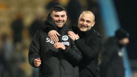 Wigan boss Shaun Maloney (right) celebrates winning through to the fourth round of the FA Cup