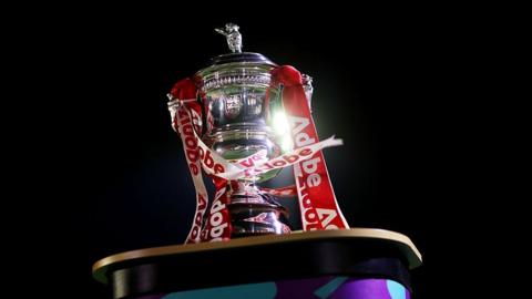 Women's FA Cup trophy with red and white ribbons
