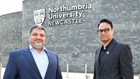 Dr Shahid Rasul (L) and Dr Jibran Khaliq (R) and of Northumbria University's School of Engineering, Physics and Mathematics stand side-by-side in front of a building at the university. Rasul has short grey/black hair and a short, neat grey beard. He has a dark blue suit jacket over a light blue shirt unbuttoned at the collar. Khaliq has short jet black hair and black, round-rimmed spectacles. He has a dark grey suit jacket on over a black shirt also unbuttoned at the collar. The Northumbria University logo is on the grey brick wall behind them, along with the institution's name in white letters above the word Newcastle in capitals.