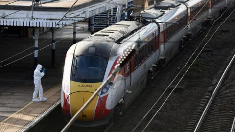A forensic officer inspects the London North Eastern Railway (LNER) train where a series of stabbings took place, at a platform at Huntingdon Station, near Cambridge, Britain, November 2, 2025