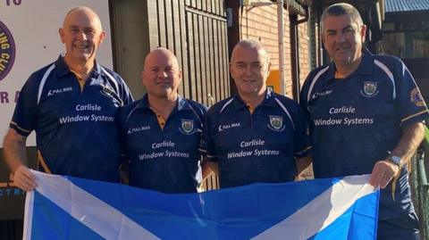 The four members of Marchmount bowling club hold a Saltire flag