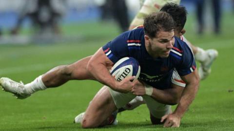 Antoine Dupont is tackled against Japan