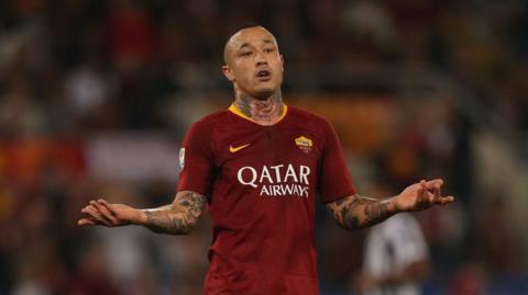 Nainggolan playing for Roma, sticking his arms out in protest