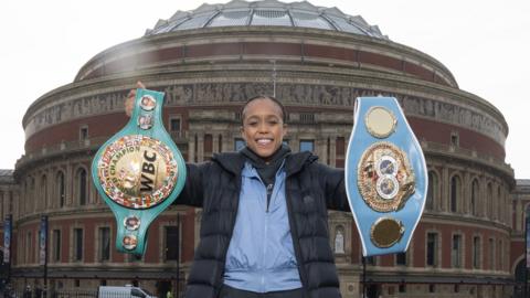 Natasha Jonas poses with world title in front of Liver building in Liverpool