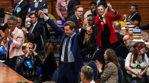 People celebrating and clapping at a count in Westminster
