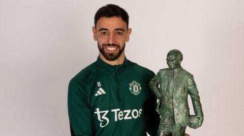 Manchester United skipper Bruno Fernandes with the 2024 Sir Matt Busby player of the year award