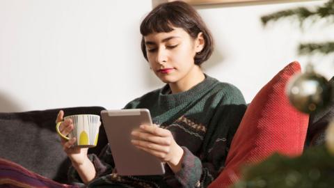 Woman relaxing with tablet pc in hand