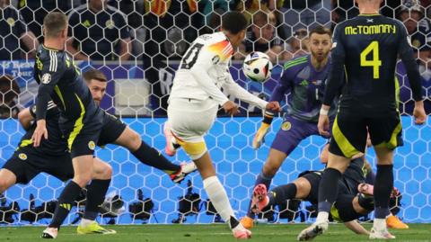 Jamal Musiala of Germany scores against Scotland