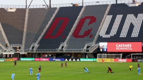 Players take a knee on the field in before the game between D.C. United and the New York City Football Club at Audi Field in Washington, D.C.,