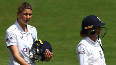 Lauren Bell and Danni Wyatt walk off after England lose to Australia