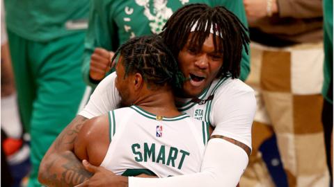 Boston Celtics' Robert Williams III and Marcus Smart hug in celebration