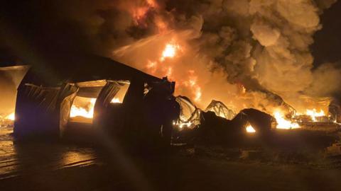 Burnt out vehicle and buildings at Capital Valley Plastics