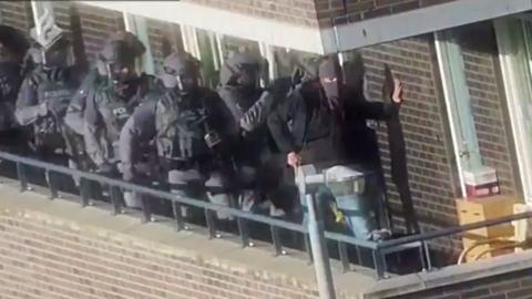 Dutch police raid a residence in Arnhem on 27 September