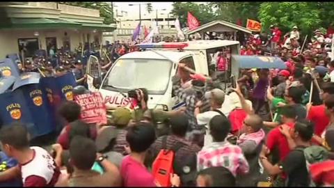 Philippines police van confronts protesters