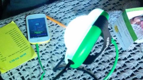 Solar lamp charging mobile phone