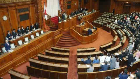 Ruling coalition lawmakers stand to accept the anti-terror law at the upper house of parliament in Tokyo on 15 June 2017.