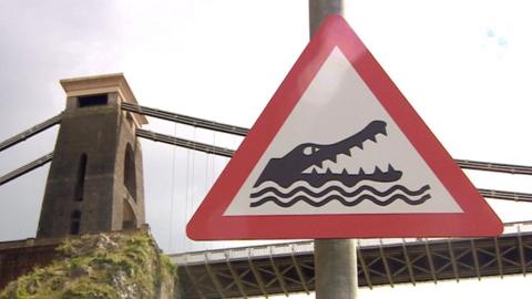 A crocodile warning red triangle sign on the Portway in Bristol