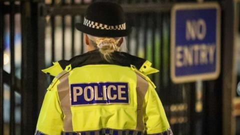 Police officer outside Oldham police station