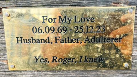 A plaque on a bench saying someone "knew" a man called Roger was an adulterer