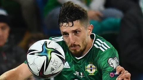 NI's Craig Cathcart heads clear against Italy in 2021