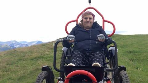 Michelle in an off-road wheelchair