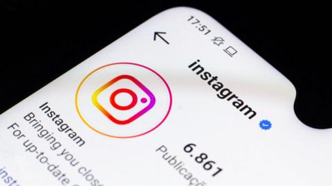 Instagram's own instagram profile on a phone, photographed up-close on the logo