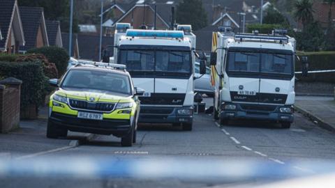 Police car and vans parked on Rosevale Avenue