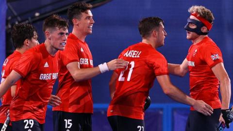 Great Britain players celebrate a goal against Belgium