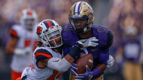 John Ross being tackled in a game for the University of Washington