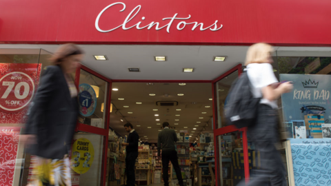 People walk past Clintons shop