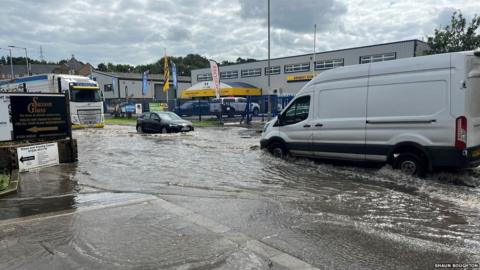 Vehicles tackle a flooded Haven Road, in Colchester