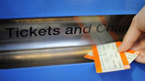 A person buying a train ticket