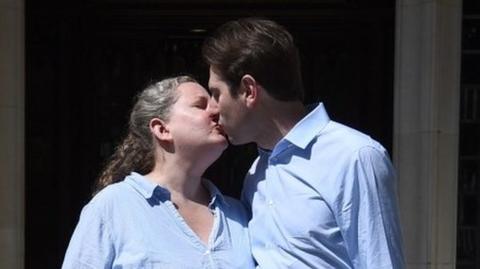Rebecca Steinfeld and Charles Keidan kiss outside the Supreme Court in London