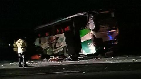 Video grab shows crashed bus by side of the road