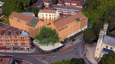 Artist impression of the redevelopment of Trinity Road police station in Old Market. It is an aeriel shot, showing a red-brick building, a tree and a road.