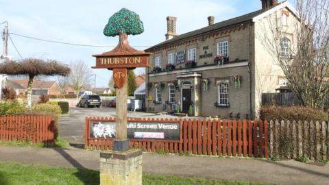 Thurston village sign and Fox and Hounds pub