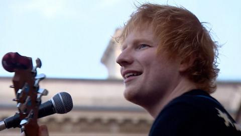 Ed Sheeran at a microphone