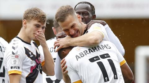 Mickey Demetriou of Newport County celebrates with Tristan Abrahams