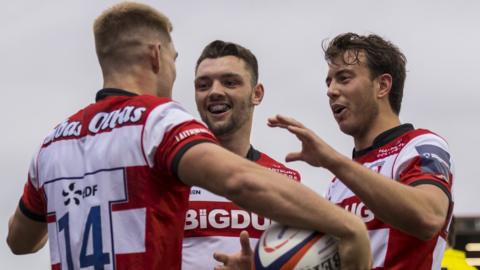 Gloucester players celebrate a try against Exeter