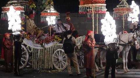 A groom sits on a horse cart during a wedding procession in New Delhi on April 21, 2015.