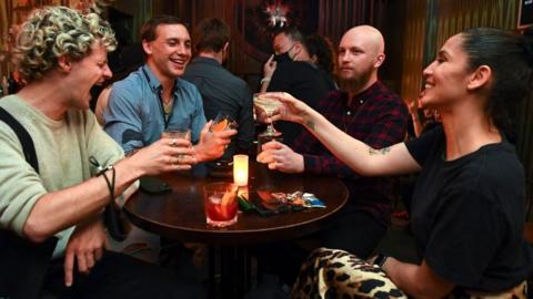 People celebrate in a bar in Melbourne