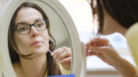 Woman takes a lateral flow test