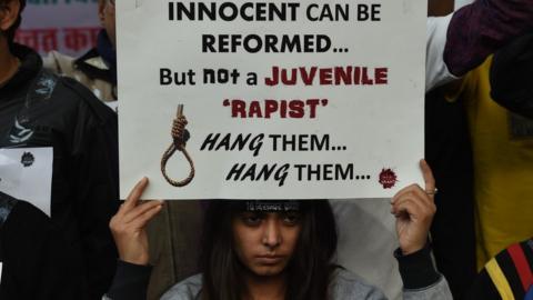 An Indian protester holds a placard during a demonstration against the release of a juvenile rapist in New Delhi on December 21, 2015. India's Supreme Court December 21, 2015 rejected an appeal against the release of the youngest convict in an infamous fatal gang-rape, sparking fury from the victim's parents who said the ruling was a betrayal of women.