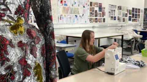 Sophie Reed working with her sewing machine