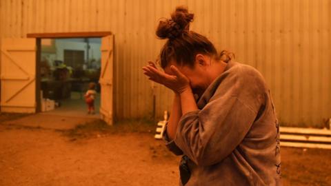 Jesse Collins who organises the donations reacts while speaking about how hard getting water has been, as bushfires continue in New South Wales, at the evacuation centre in Cobargo, Australia January 5, 2020.